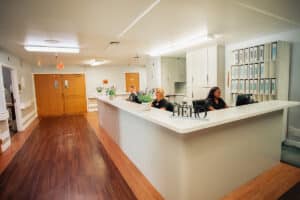 Del Rosa nurses' station with three caregivers at computers.