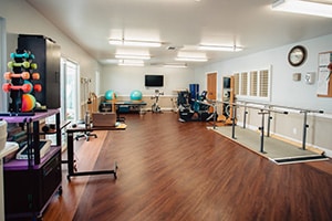 three nurses standing at the nurse's station at Del Rosa Villa Nursing Center