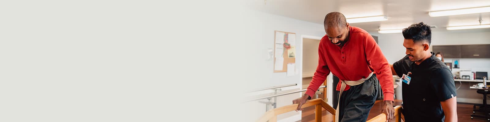 A rehab therapist helping a resident on the stairs in the rehab gym at Del Rosa Villa Nursing Center